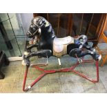 A child's tinplate bouncy horse