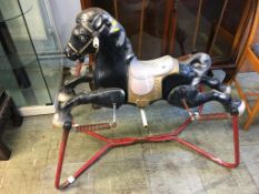 A child's tinplate bouncy horse