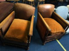 A pair of 1930's brown leather and barley twist oak framed armchairs