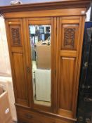 An Edwardian mirror door wardrobe