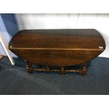 An Ercol oak drop flap table