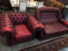 A Chesterfield red leather two seater settee and a club armchair