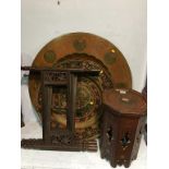 A carved octagonal table, a large decorative circular plaque and a folding Indian table