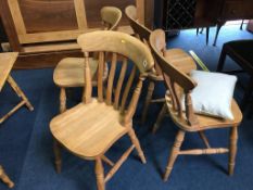 Four pine chairs and a bamboo table