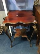 An Edwardian carved mahogany square occasional table