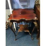 An Edwardian carved mahogany square occasional table