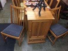 A pair of Ercol Golden Dawn chairs and a cabinet