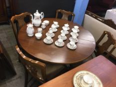 An oak circular table and four chairs