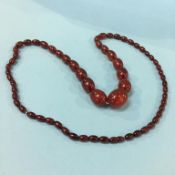 A string of amber coloured beads, weight 106 grams