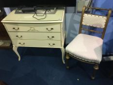 A cream chest of three drawers and a gilt single chair