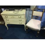 A cream chest of three drawers and a gilt single chair