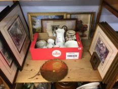 A shelf of assorted pictures, prints and china etc.