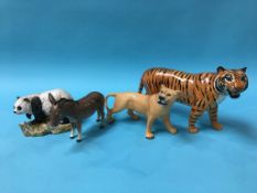 A Beswick Tiger, Lioness, Donkey and a figure of a Panda