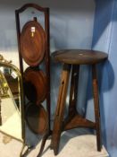 An oak Arts and Crafts circular two tier table, and a mahogany cake stand