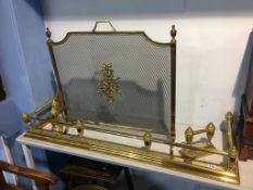A brass fender, dogs and a fire screen