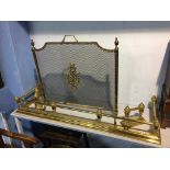 A brass fender, dogs and a fire screen