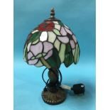 A small Tiffany style table lamp