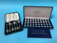 A boxed set of 'The Great Airplanes Sterling Silver Miniature Collection' and six silver teaspoons