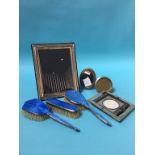 A silver enamelled dressing table set and a selection of silver photograph frames