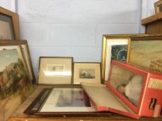 A shelf of assorted pictures and prints, and a Chiltern doll