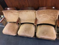 A set of three folding old cinema seats