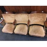 A set of three folding old cinema seats