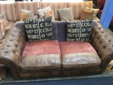 A large tan brown leather Chesterfield button back settee, with part cloth (as new)