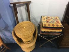 A glass and chrome folding table, wicker chair and table and four cushions