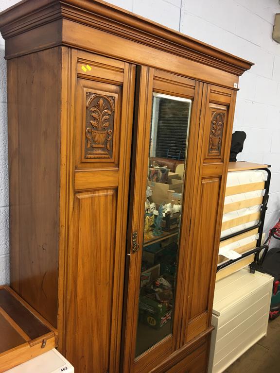 An Edwardian mirror door wardrobe