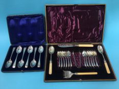 A set of silver cased silver spoons and a case of plated cutlery