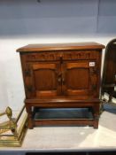 A small oak two door cabinet