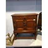 A small oak two door cabinet