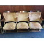 A set of three folding old cinema seats