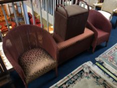 A pair of pink Lloyd Loom chairs, an ottoman and a linen box