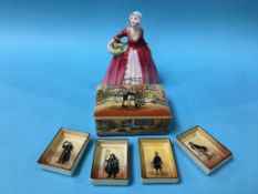 A Doulton Series Ware 'Sam Weller' box and cover, four small dishes and a Doulton figurine 'Janet'