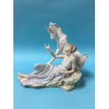 A Lladro group of a Lady reclining beside a Unicorn