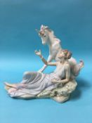 A Lladro group of a Lady reclining beside a Unicorn