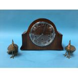 A walnut mantel clock and a pair of metal work Peacocks