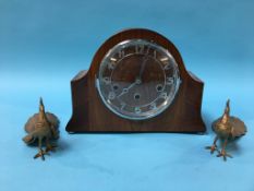 A walnut mantel clock and a pair of metal work Peacocks