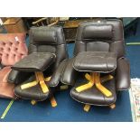 A pair of brown armchairs, with stools