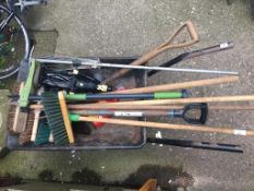 A wheelbarrow and garden tools