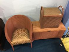 A pink Lloyd Loom ottoman, linen box and chair