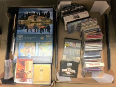 Two boxes including CDs and puzzles