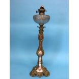 A tall decorative ormolu and frosted glass oil lamp, with porcelain core, 73cm high