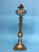 A tall decorative ormolu and frosted glass oil lamp, with porcelain core, 73cm high