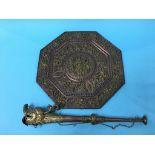 A South East Asian copper and brass octagonal wall plaque and a horn