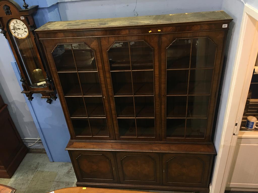 A walnut three door bookcase, 150cm wide, 190cm high