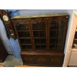 A walnut three door bookcase, 150cm wide, 190cm high