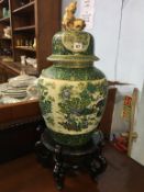 A large Chinese decorative vase and cover, with wooden stand, overall size 78cm high Condition