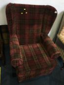 A tartan upholstered wing armchair